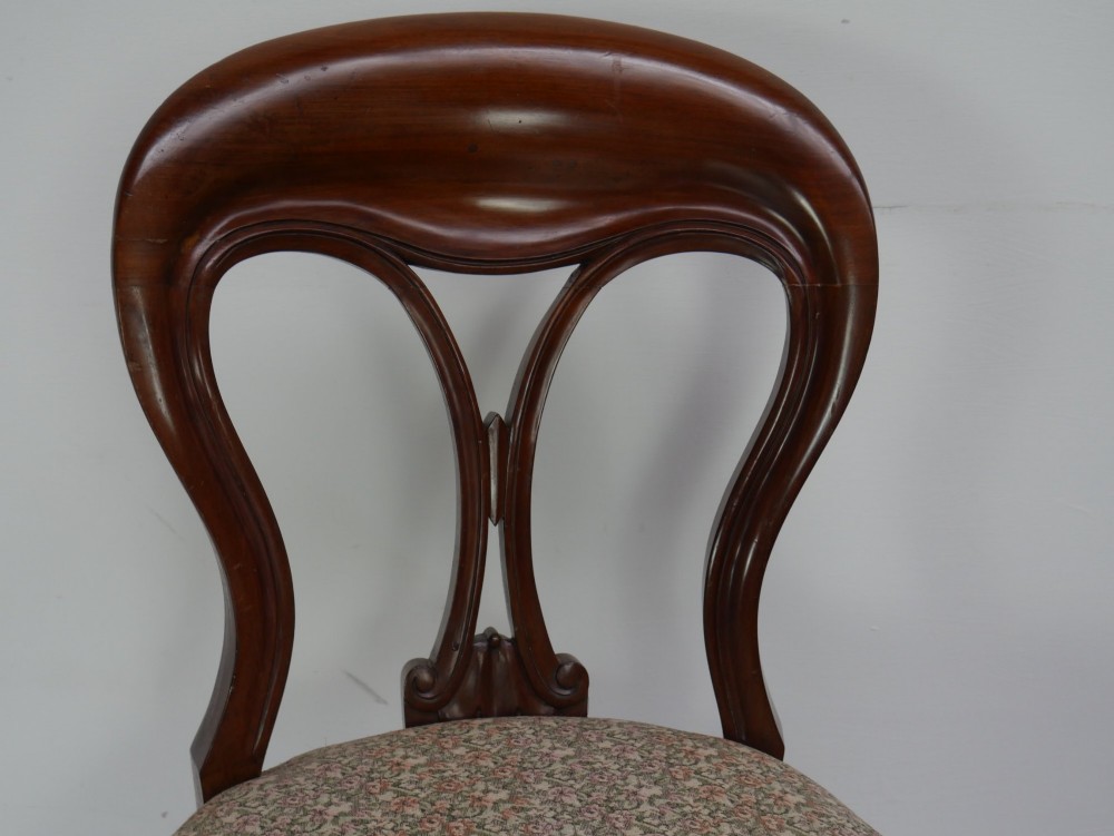 A set of four 19th-century mahogany dining chairs with carved open backs, upholstered seats, and cabriole legs. View XI