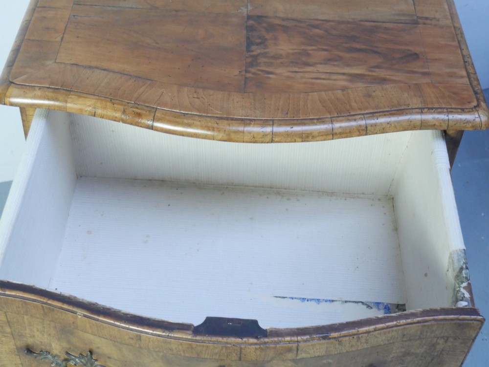 An 18th-century Swedish wooden commode featuring two bow-fronted drawers, ornamental brass handles, escutcheons, and curved lower legs. View VII