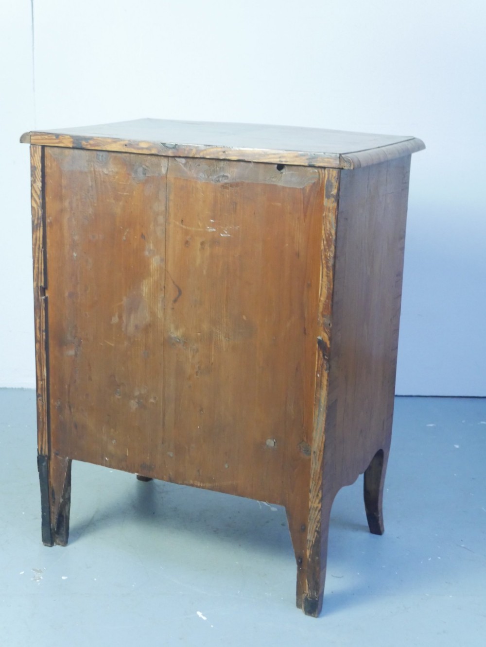 An 18th-century Swedish wooden commode featuring two bow-fronted drawers, ornamental brass handles, escutcheons, and curved lower legs. View IX