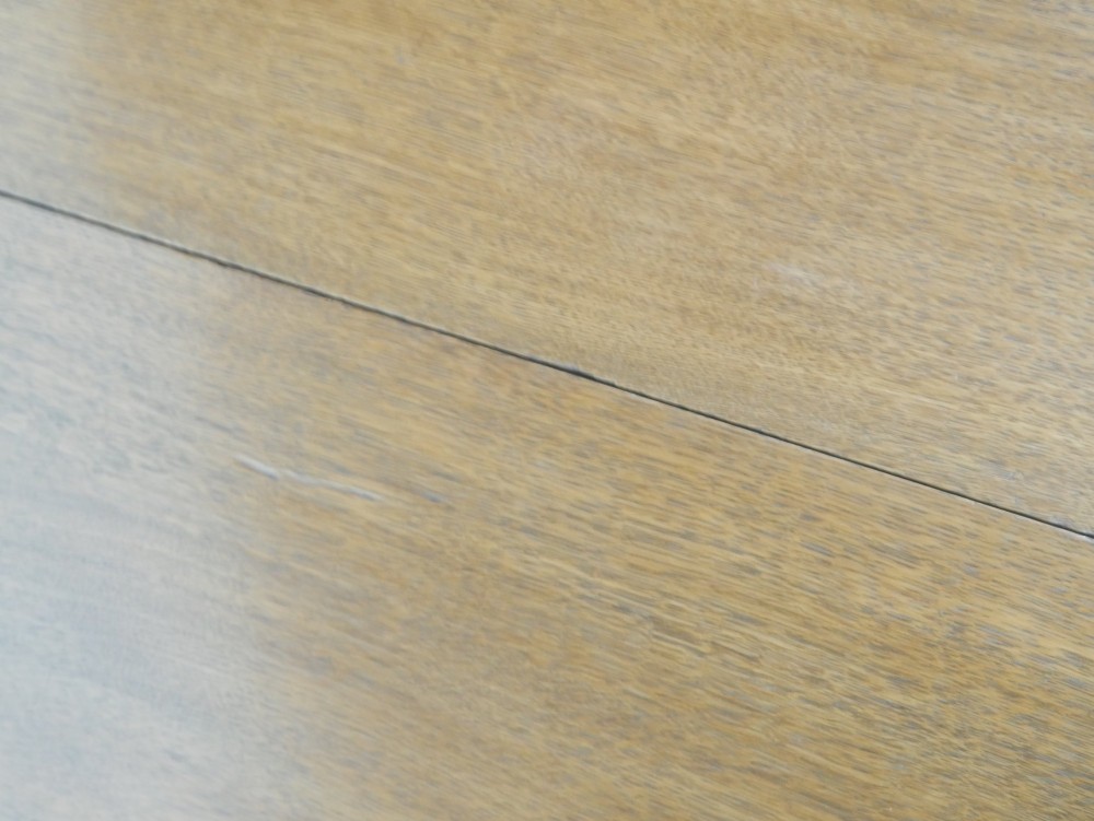 A 19th-century oak extending dining table featuring turned baluster legs set on brass castors with an inserted extension leaf. View VIII
