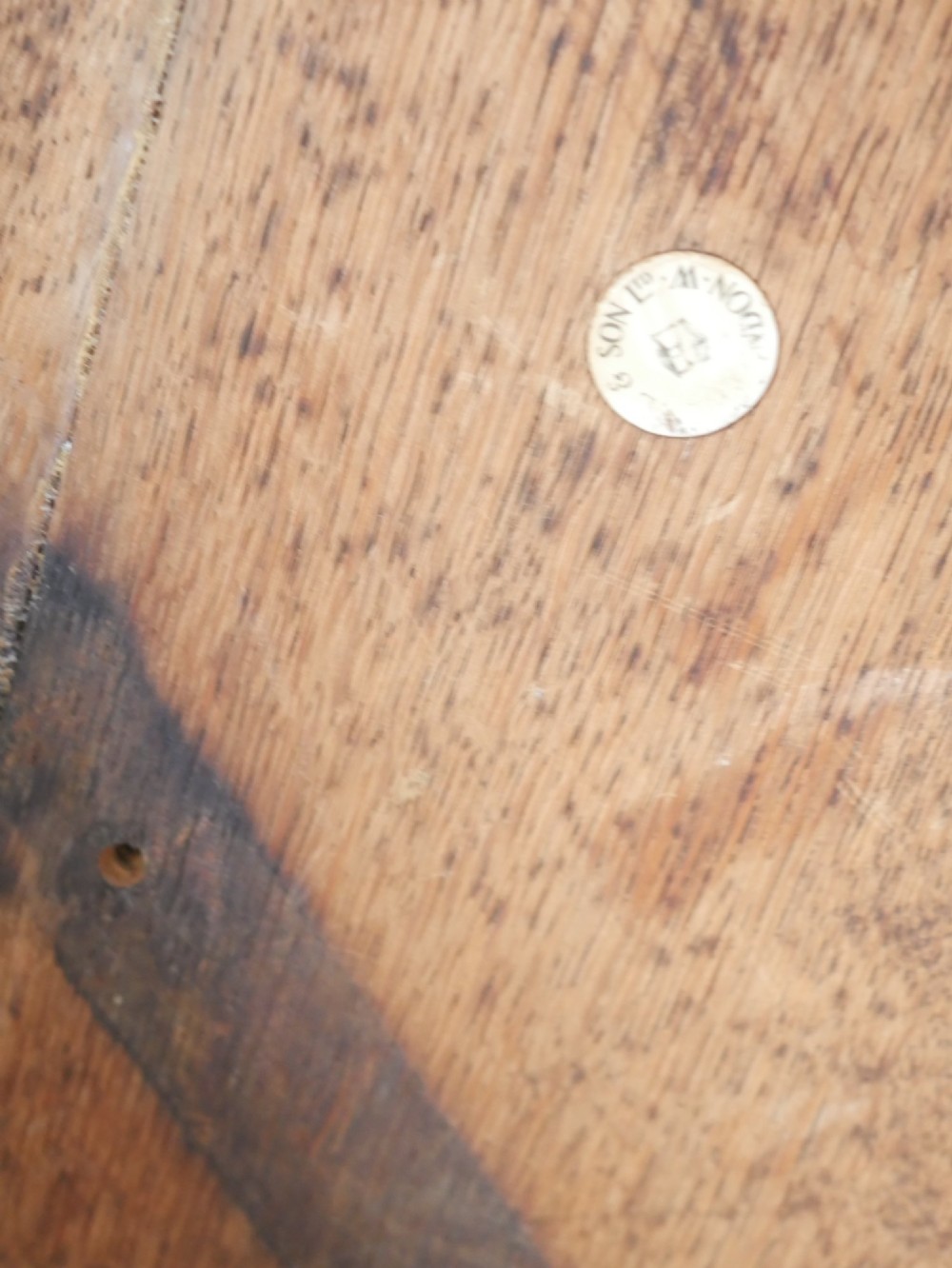 A circular solid oak centre table featuring splayed square legs connected by a central cross-stretcher. View IX