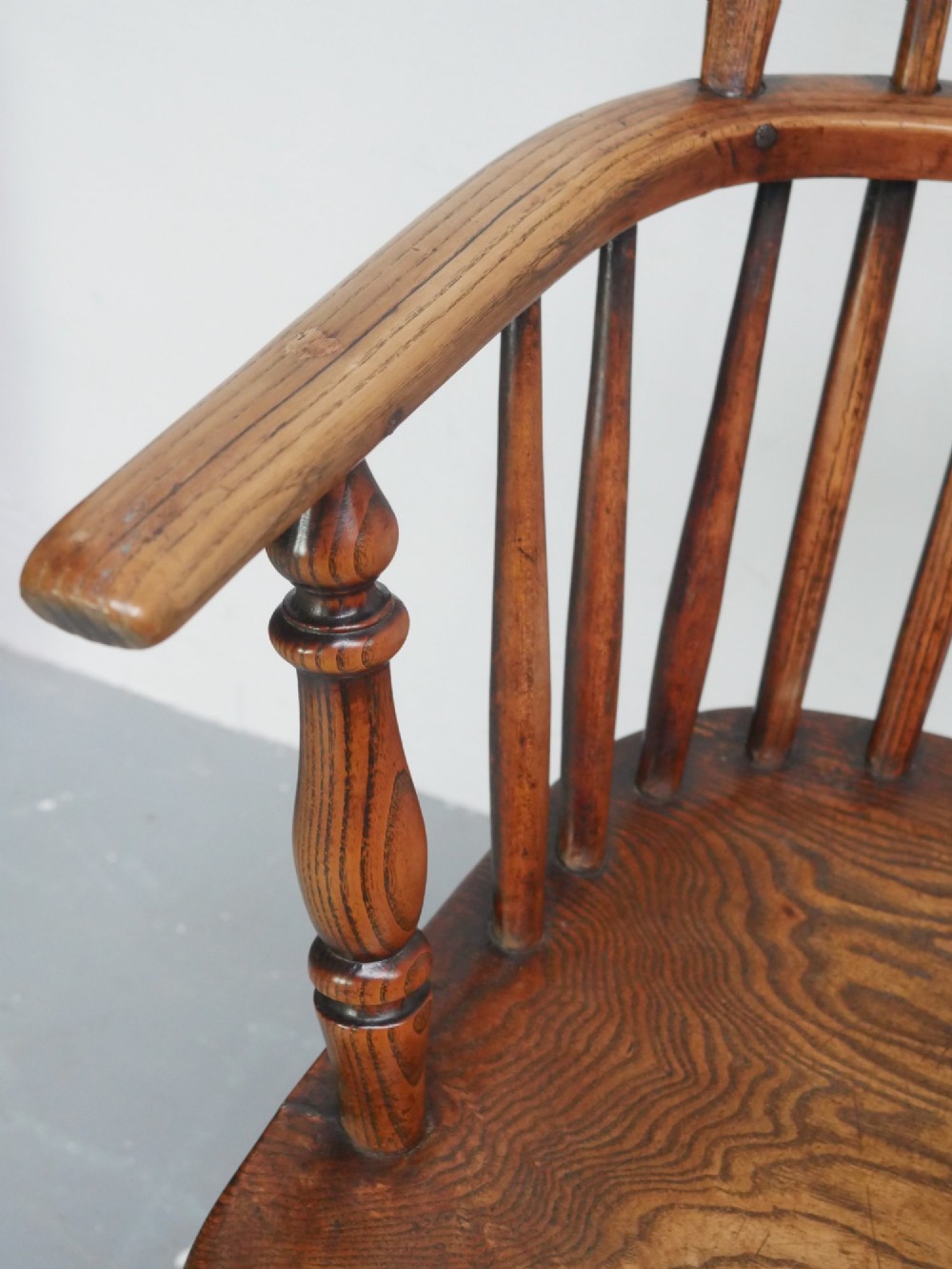 A warm brown wooden Scottish Windsor armchair featuring a hoop back with vertical spindles, shaped saddle seat, and turned legs. View VIII