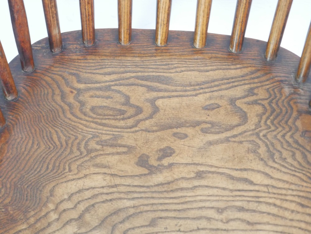 A warm brown wooden Scottish Windsor armchair featuring a hoop back with vertical spindles, shaped saddle seat, and turned legs. View IX