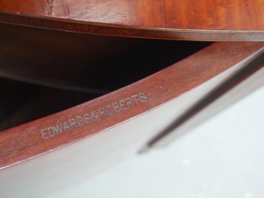 An antique mahogany display cabinet featuring marquetry urn inlays on lower doors, curved bowfront glass doors, glass shelves, and a swan-neck pediment. View VI