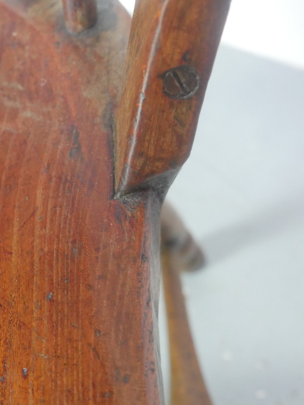 A mid-19th-century warm brown wooden Windsor armchair featuring a double-tier spindle back, carved saddle seat, curved armrests, and turned legs. View XII