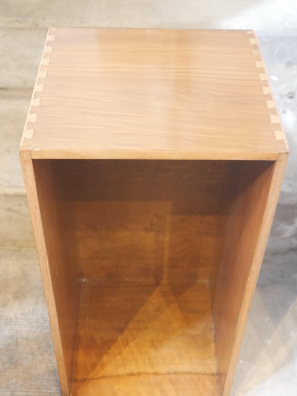 A group of three rectilinear open wooden display boxes with warm timber grain. View II