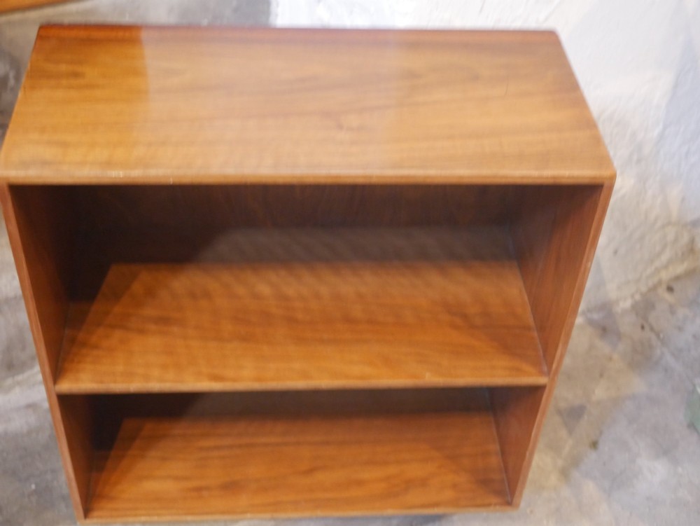 A group of three rectilinear open wooden display boxes with warm timber grain. View VI