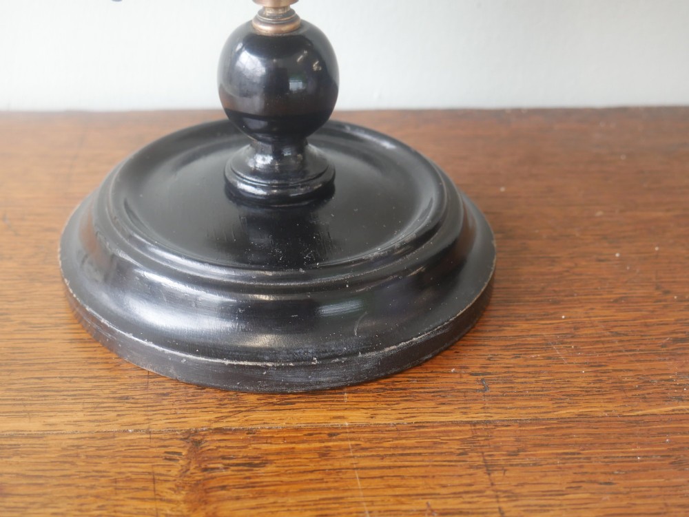 An antique terrestrial desk globe titled Philips British Empire Globe featuring cream paper gores mounted on a brass semi-meridian arm and an ebonised turned wooden base. View III