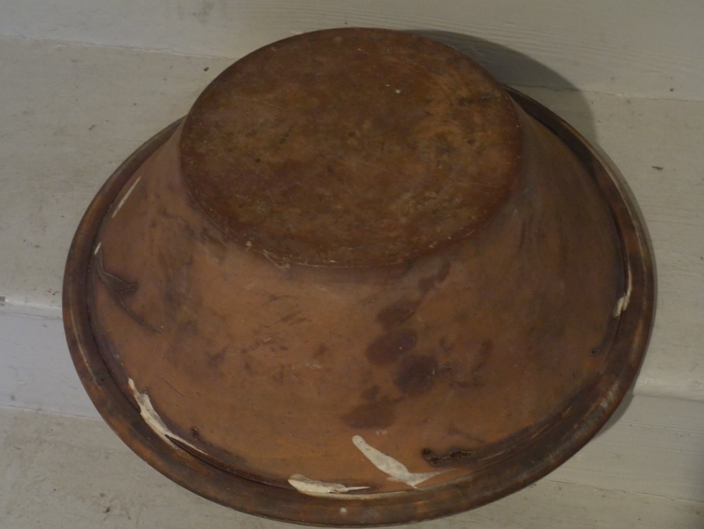 A circular glazed earthenware dairy bowl featuring dark brown slip decorations, geometric borders, central star motifs, and inscribed script lettering on a cream ground. View III