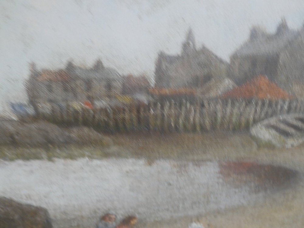 An antique oil painting depicting a coastal village harbour scene with figures along the shore, displayed within an ornate gold swept frame. View VI