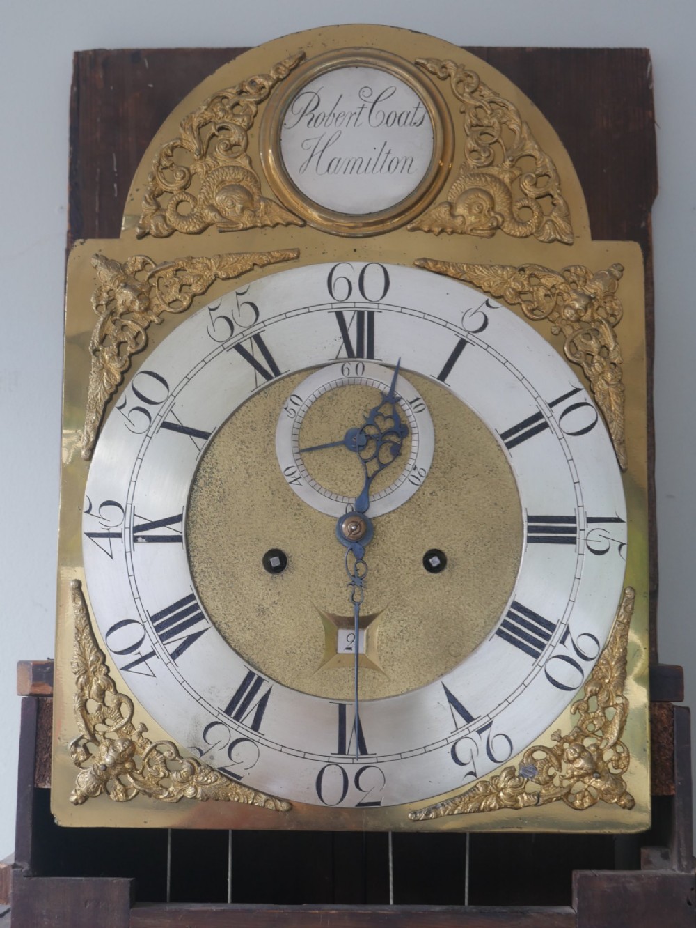 A tall Scottish mahogany longcase clock featuring a swan-neck pediment with brass finials, fretwork details, and an brass dial with silvered chapter ring. View III