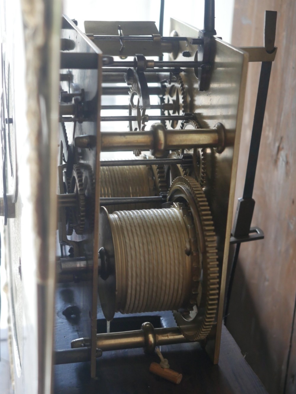 A tall Scottish mahogany longcase clock featuring a swan-neck pediment with brass finials, fretwork details, and an brass dial with silvered chapter ring. View VI
