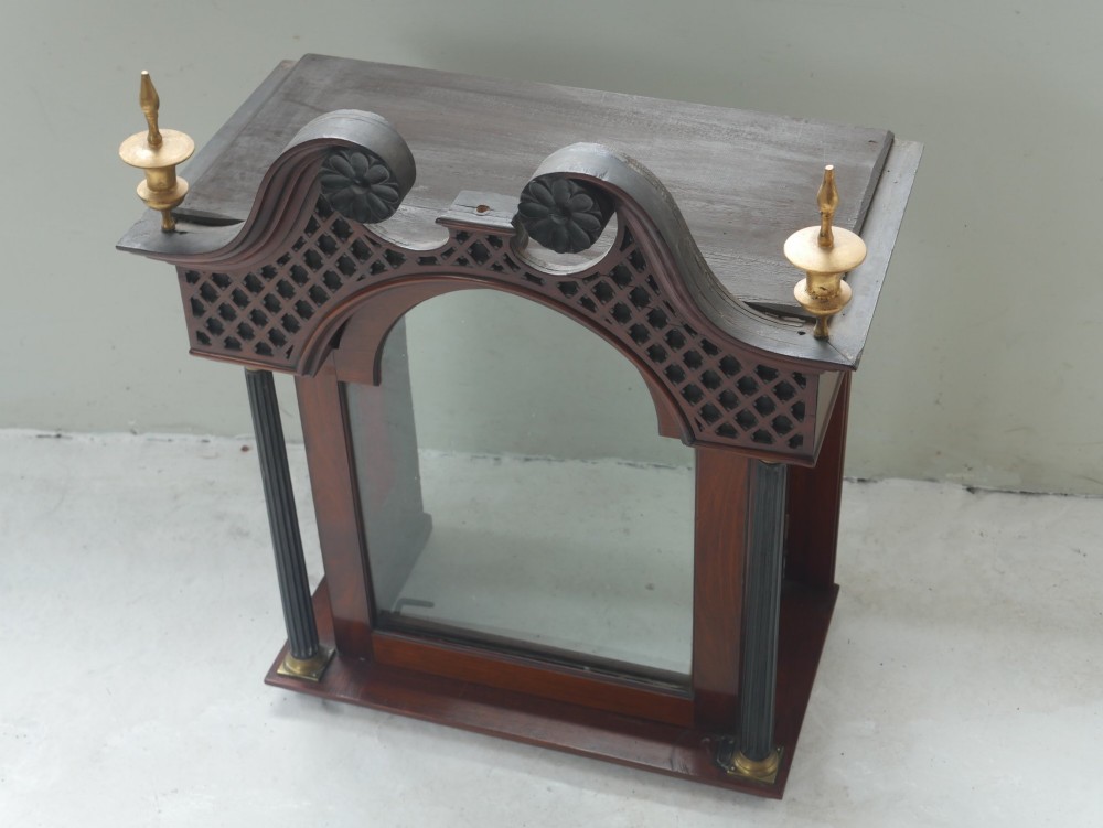 A tall Scottish mahogany longcase clock featuring a swan-neck pediment with brass finials, fretwork details, and an brass dial with silvered chapter ring. View XI