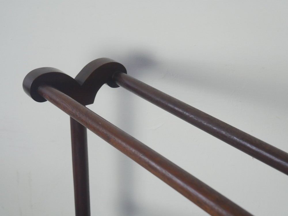 A dark mahogany freestanding towel rail featuring scrolled top terminals, turned vertical posts, and multiple horizontal drying bars supported on sledge feet. View II