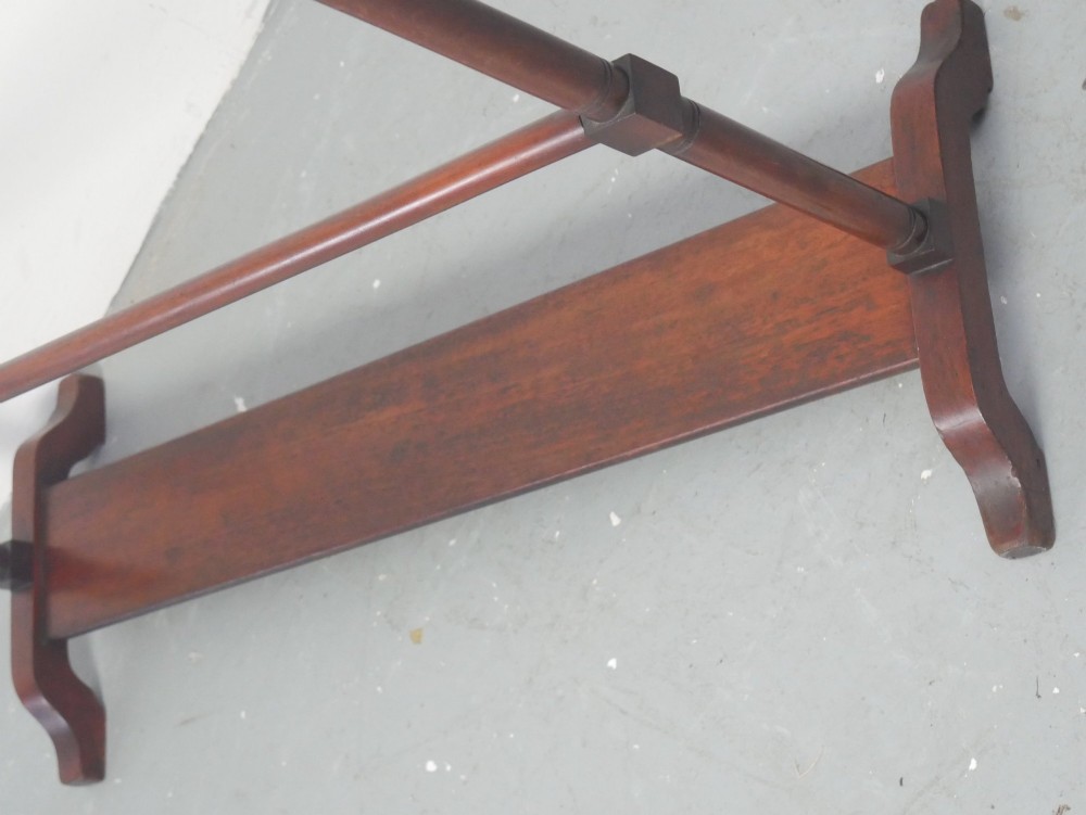 A dark mahogany freestanding towel rail featuring scrolled top terminals, turned vertical posts, and multiple horizontal drying bars supported on sledge feet. View III