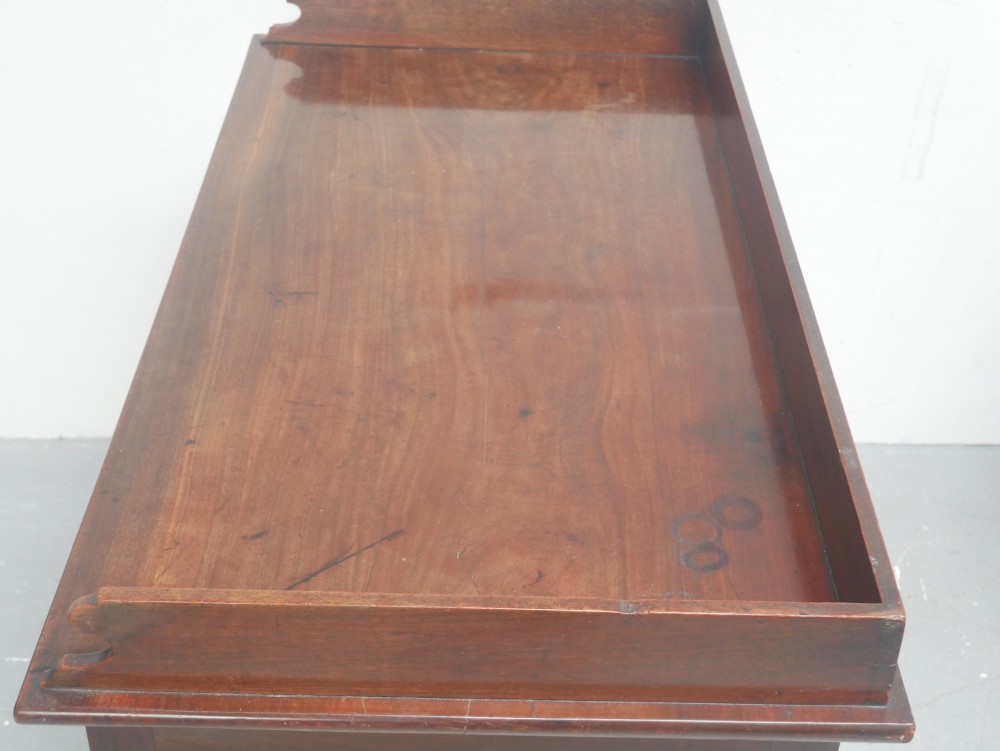 An antique Regency mahogany writing table featuring a raised gallery back, two frieze drawers with line inlay, and turned legs. View II