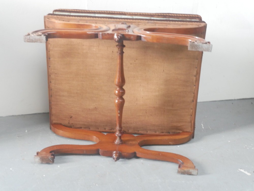 An antique Scottish Baronial X-frame stool crafted from carved wood with scrolled feet, turned finials, and a brown velvet seat with floral tapestry top. View XI