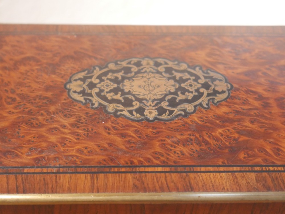 A 19th-century French amboyna wood box featuring canted corners, brass edging, and central brass inlay on the lid. View III
