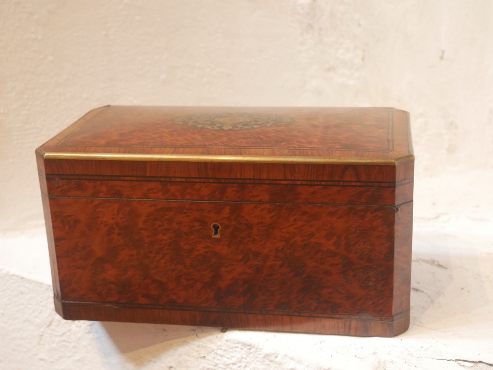A 19th-century French amboyna wood box featuring canted corners, brass edging, and central brass inlay on the lid. View VIII