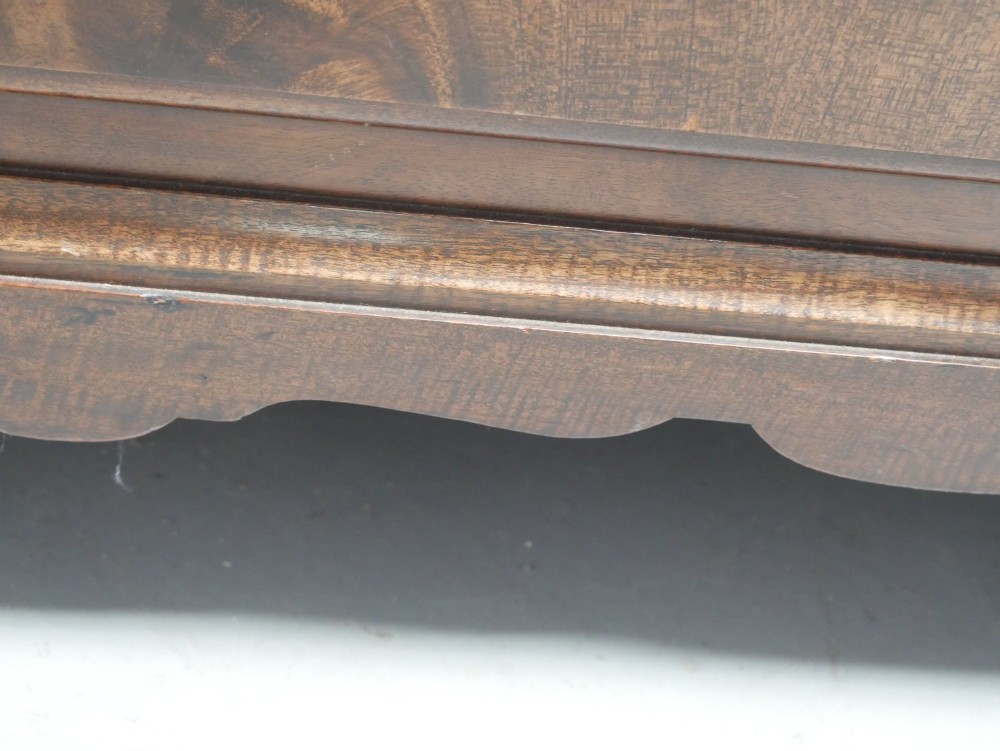 A wide Scottish flame mahogany chest of drawers featuring top diamond-inlaid frieze drawers, brass drop handles, and turned feet. View IX