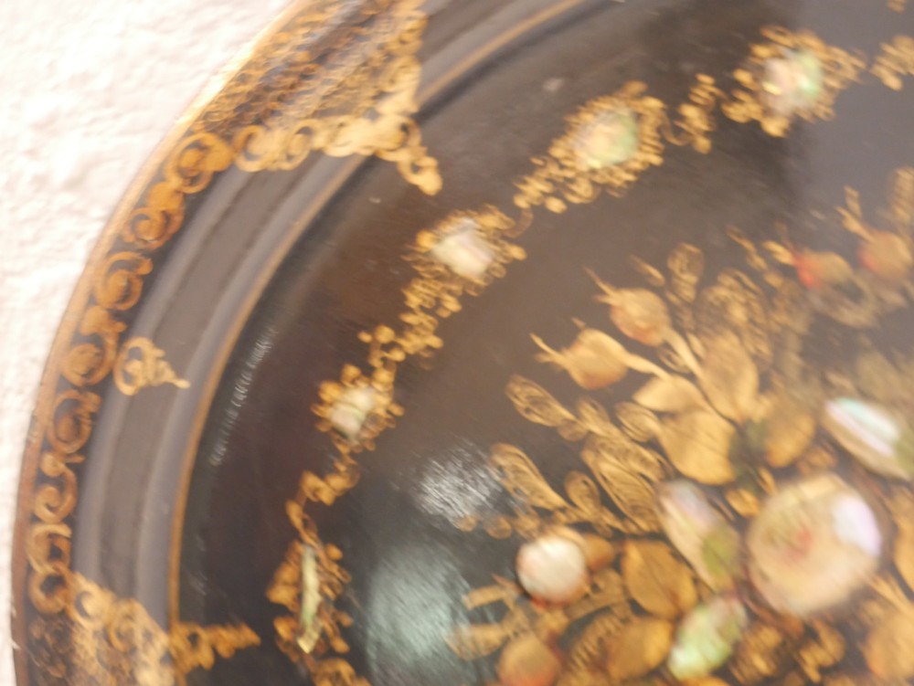 An oval black lacquered papier-mache tray decorated with gilt floral scrollwork and iridescent mother-of-pearl inlay. View IV