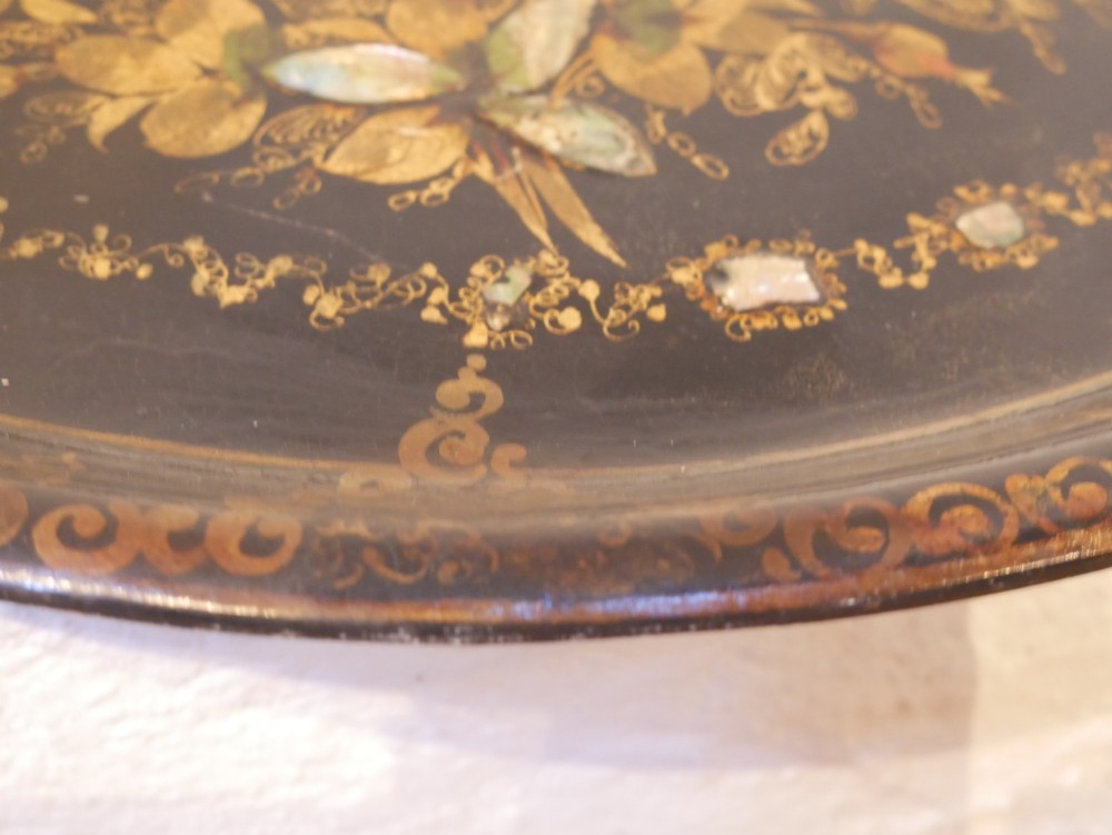 An oval black lacquered papier-mache tray decorated with gilt floral scrollwork and iridescent mother-of-pearl inlay. View VIII