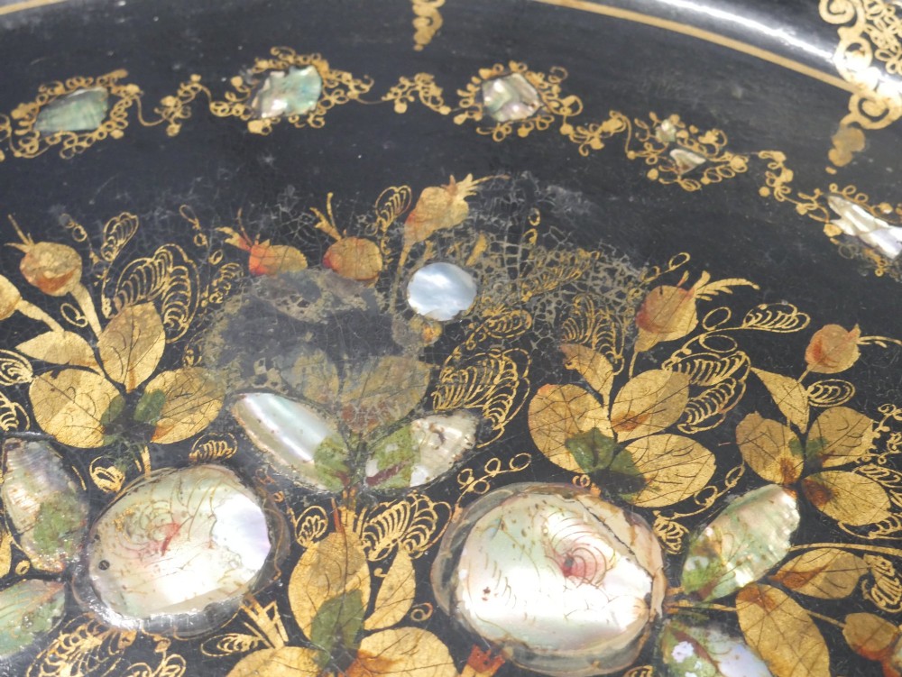 An oval black lacquered papier-mache tray decorated with gilt floral scrollwork and iridescent mother-of-pearl inlay. View X