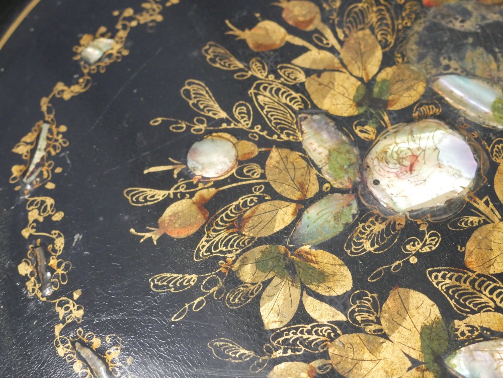 An oval black lacquered papier-mache tray decorated with gilt floral scrollwork and iridescent mother-of-pearl inlay. View XII