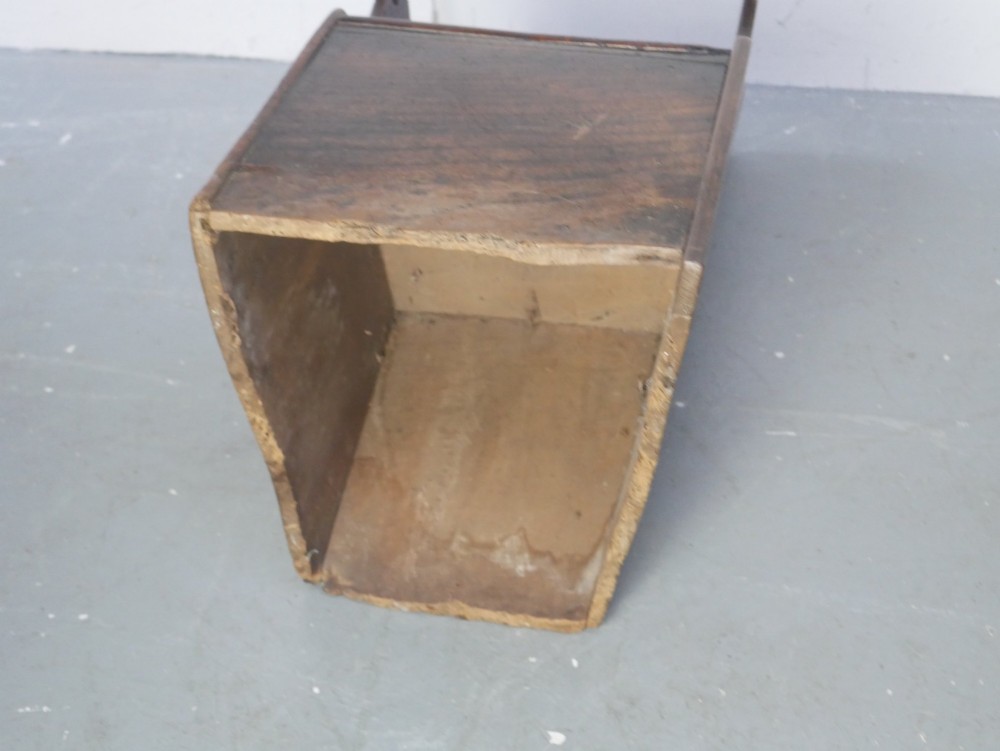 An 18th-century dark oak childs chair featuring a high winged back with decorative pierced cutouts and a solid box base. View X