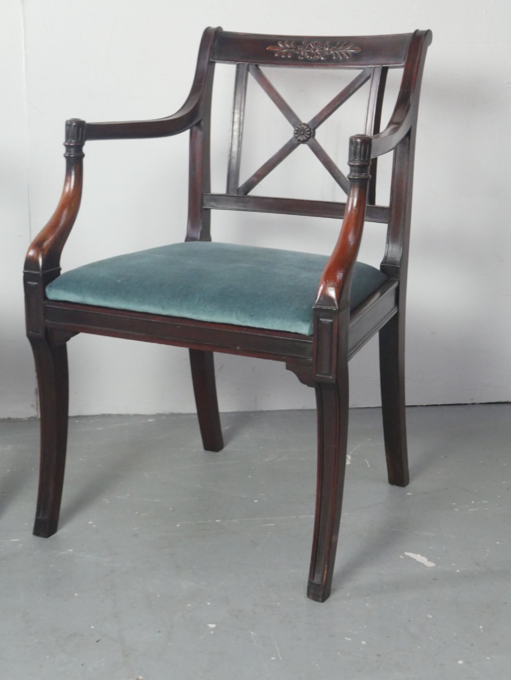 A pair of dark mahogany Regency Revival armchairs featuring cross-back splats, curved arms, and teal velvet upholstered seats. View II