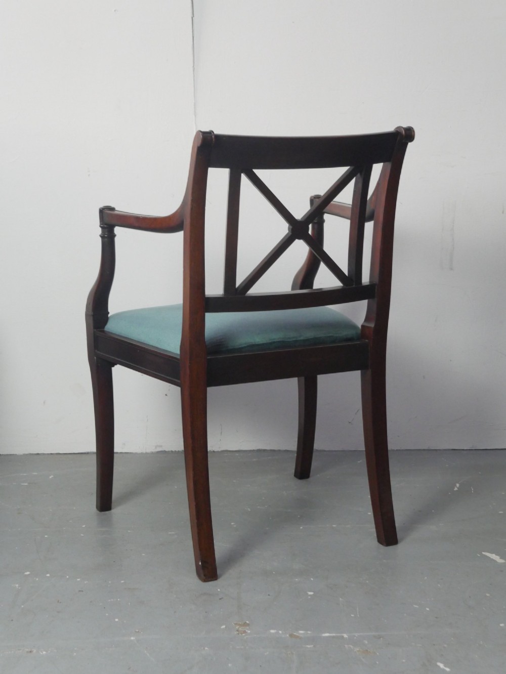 A pair of dark mahogany Regency Revival armchairs featuring cross-back splats, curved arms, and teal velvet upholstered seats. View VII