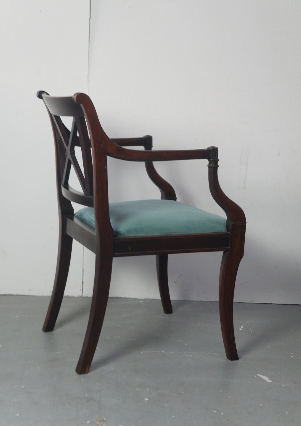 A pair of dark mahogany Regency Revival armchairs featuring cross-back splats, curved arms, and teal velvet upholstered seats. View VIII
