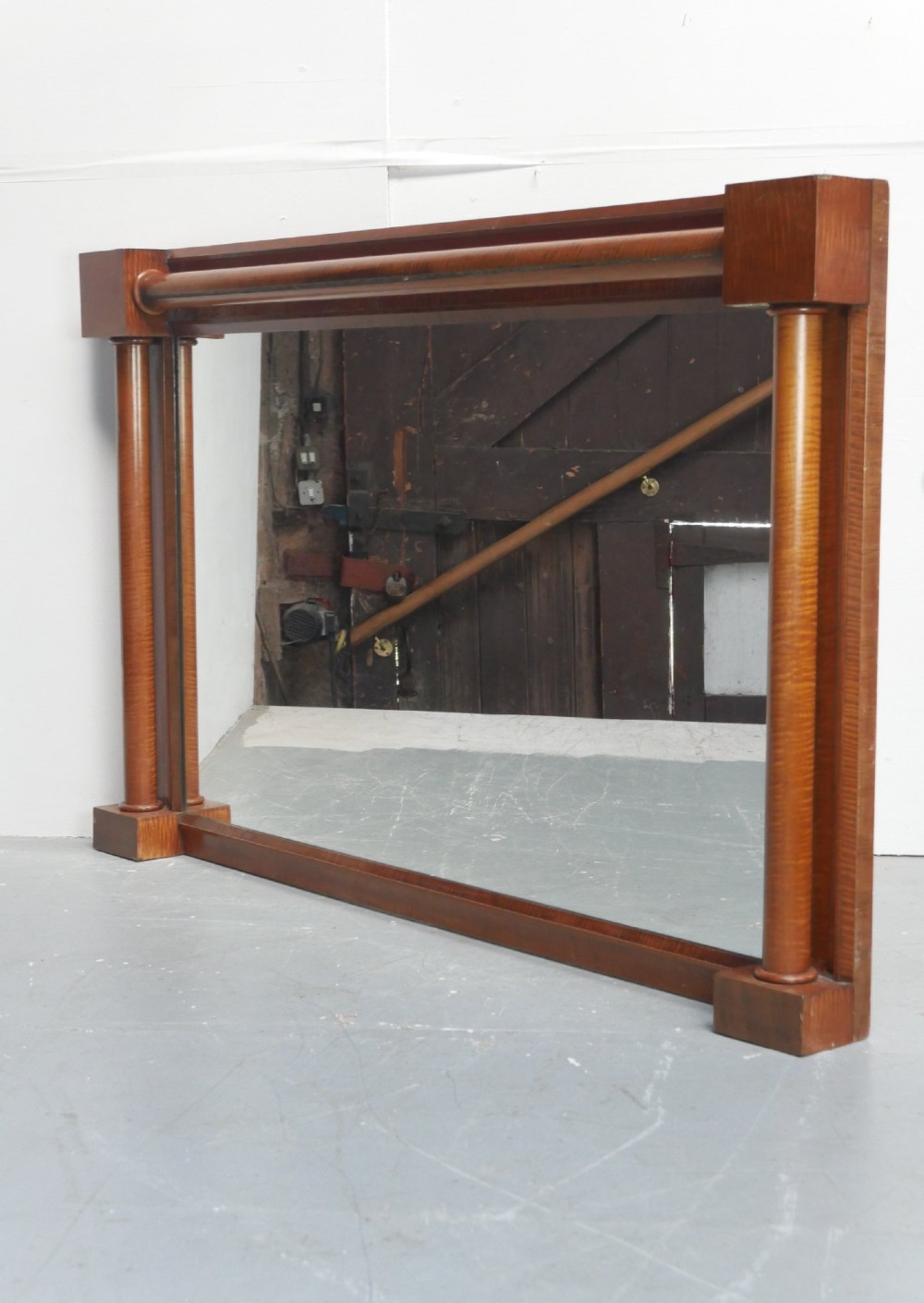 A large rectangular wall mirror crafted with a satin birch wood frame featuring architectural column details along the sides.