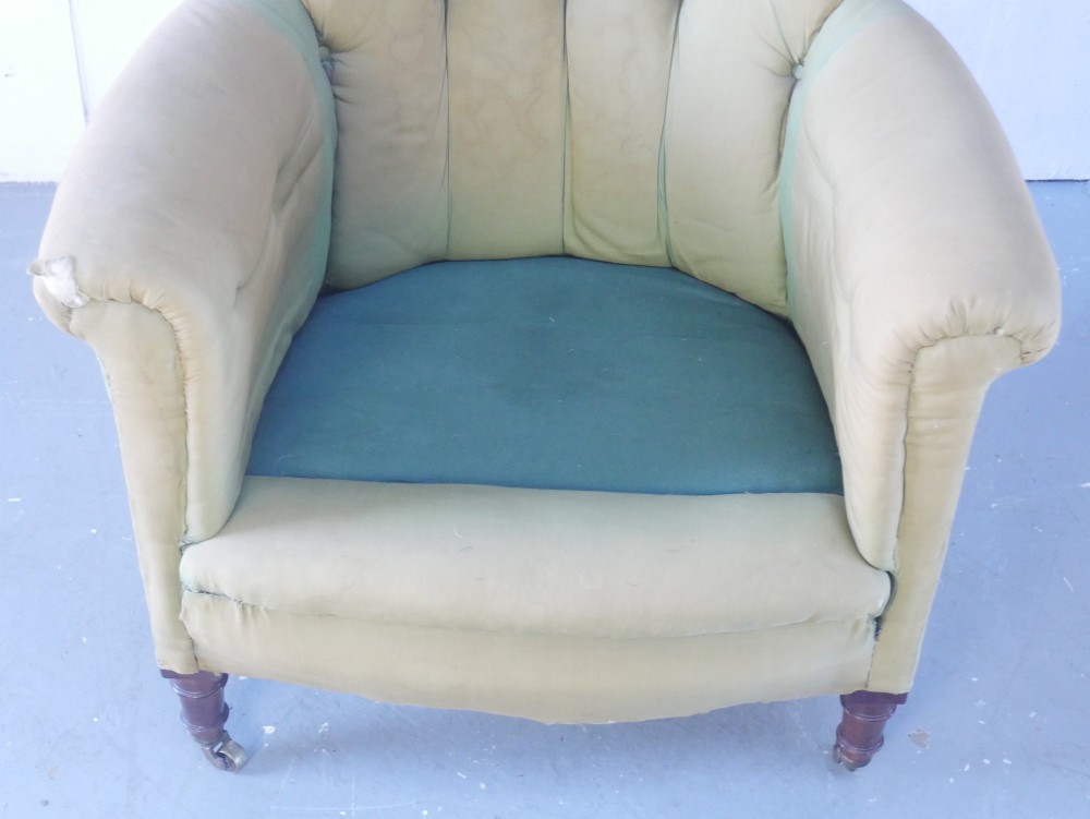 A 19th-century Victorian armchair upholstered in olive fabric with a button-backed scroll back, turned timber front legs on brass castors, and a fitted seat cushion. View IX