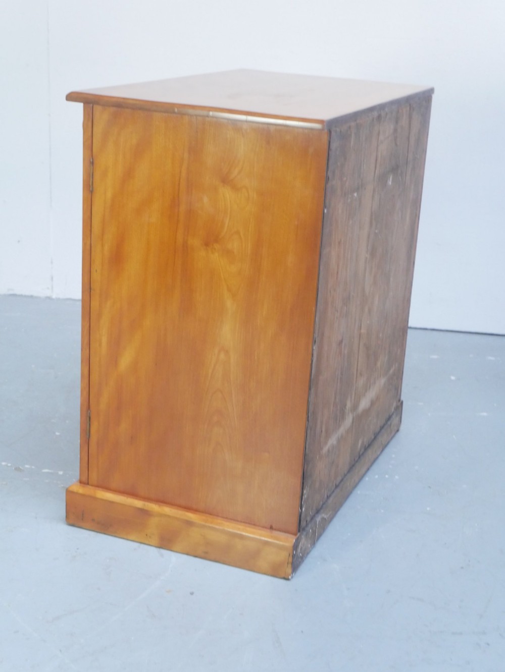 An antique Scottish wooden chest featuring four full-width drawers with dark turned handles and carved roundel details at the upper corners. View VIII