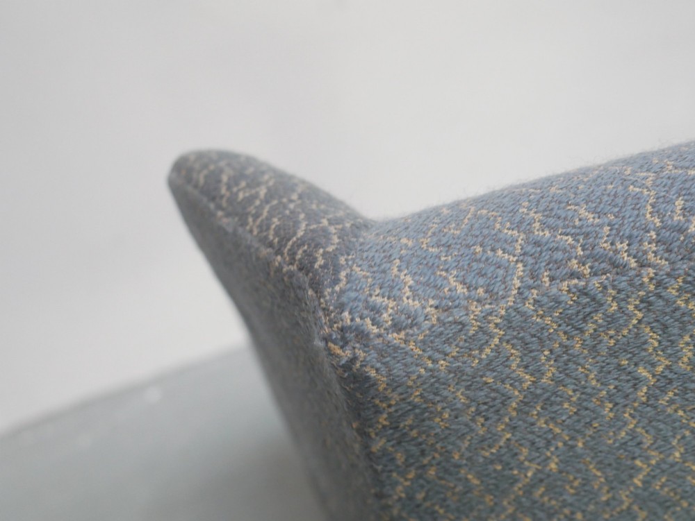 A Scottish wingback armchair upholstered in patterned slate blue fabric featuring mahogany cabriole front legs and brass stud detailing along the lower frame. View VII