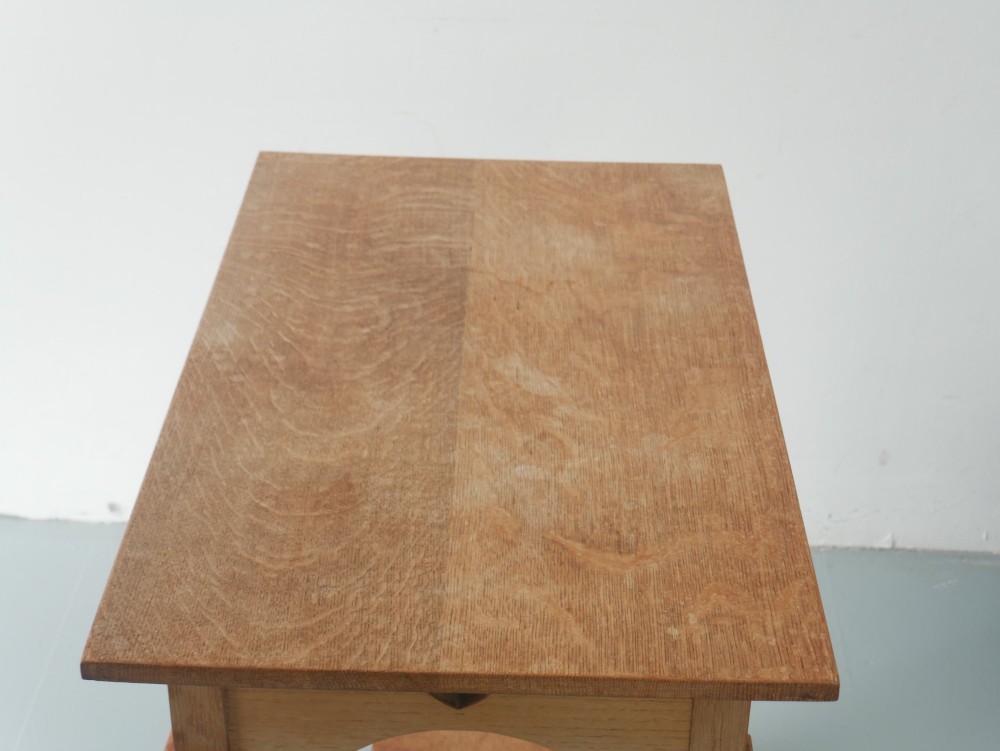 An Arts and Crafts oak lamp table featuring heart cut-out details on the apron, tapered square legs, and a contoured undertier shelf. View III