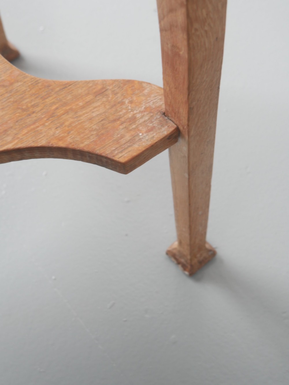 An Arts and Crafts oak lamp table featuring heart cut-out details on the apron, tapered square legs, and a contoured undertier shelf. View V