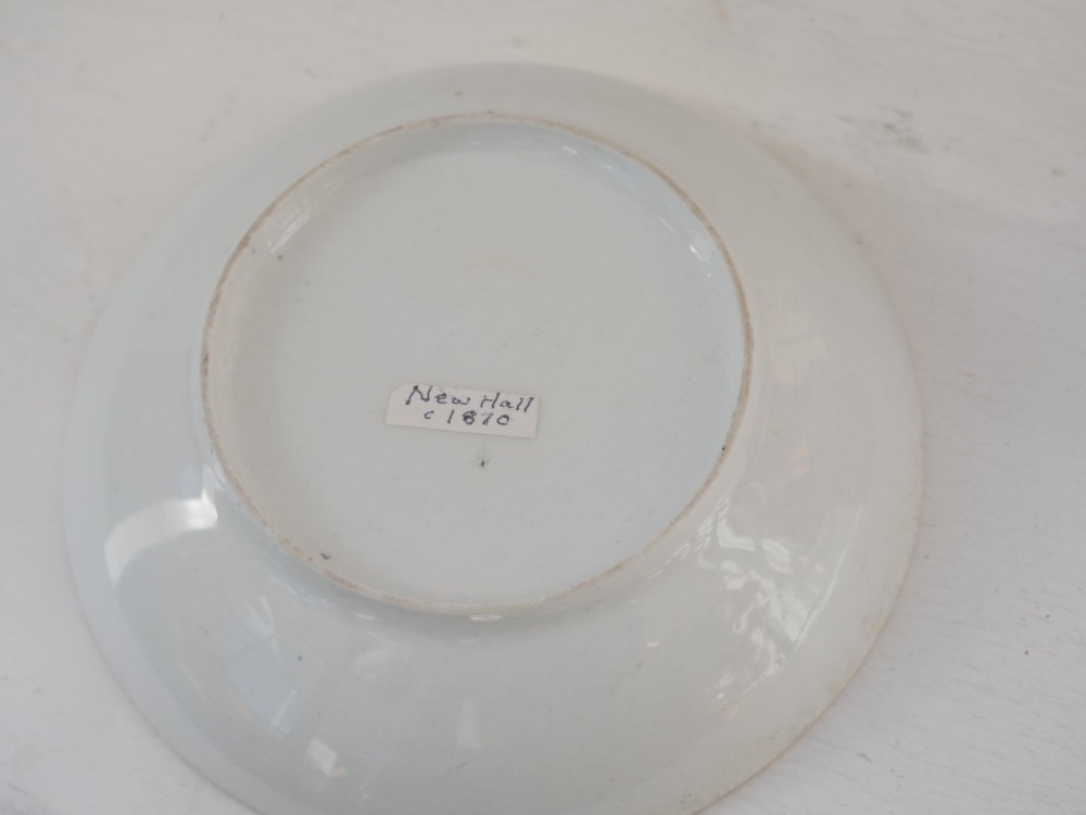 An antique porcelain teacup and matching saucer featuring cobalt blue borders with gold foliate motifs and central monochrome pastoral scenes. View IV