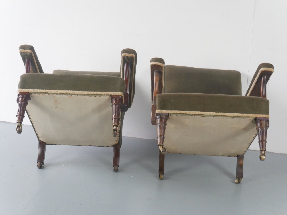 A matched pair of armchairs upholstered in olive green velvet with fringed seat cushions and turned front legs on brass castors. View IX