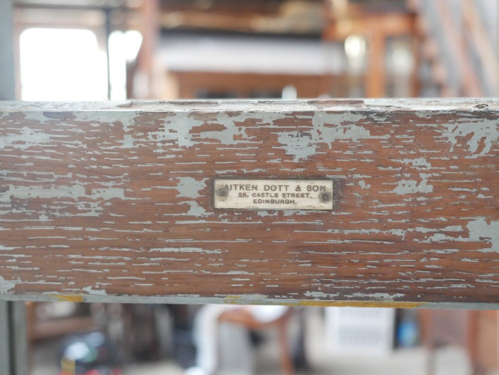 A large floor-standing double-sided timber studio easel with a distressed grey finish, adjustable height mechanism, and metal castor feet. View VII
