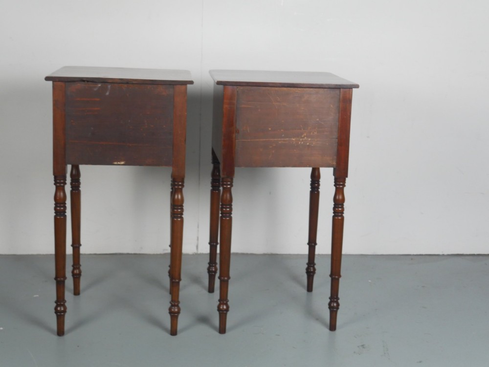 A matching pair of tall mahogany Regency bedside cupboards featuring single panel doors with small handles and slim turned legs. View III