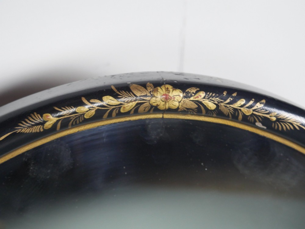 An arched black lacquer wall mirror decorated with gold hand-painted chinoiserie details and sectioned bevelled glass. View II