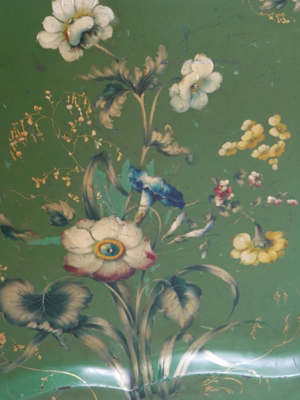 An antique 19th-century olive green painted metal toleware tray featuring a scalloped rim and hand-painted botanical flowers with gilded accents. View VI