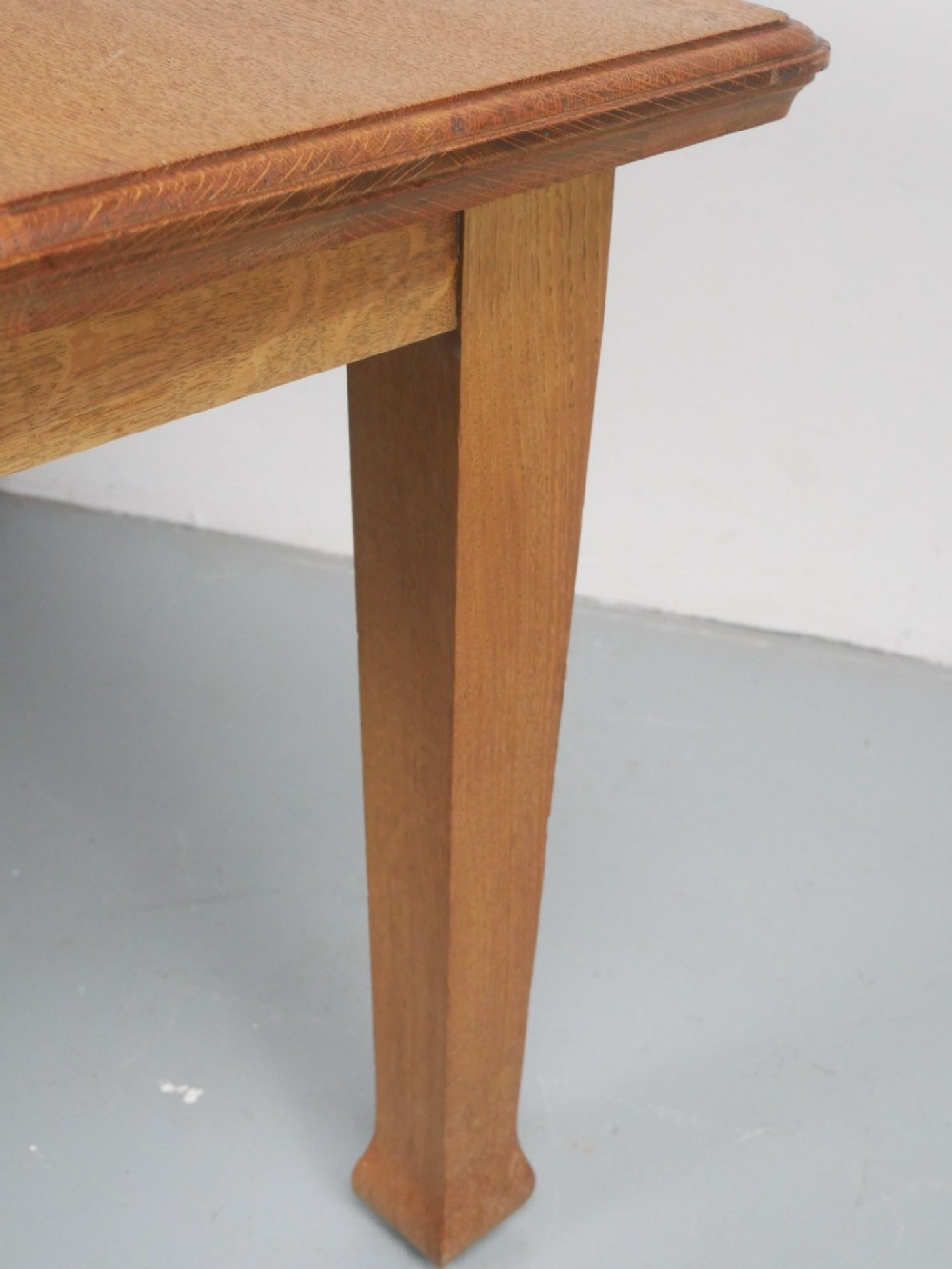 A rectangular solid oak kitchen dining table featuring shaped legs and a moulded edge top. View VII