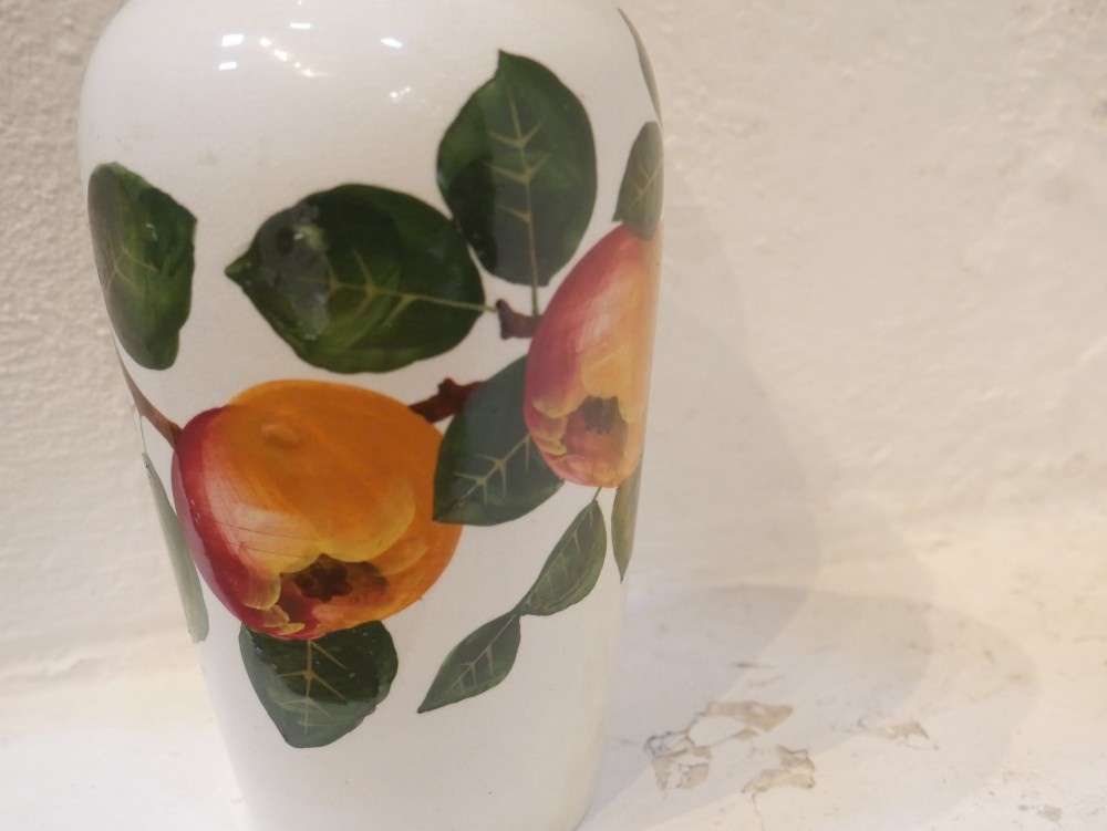 A cylindrical cream earthenware vase hand-painted with green leaves, yellow apples, and a green scalloped rim detail. View VII