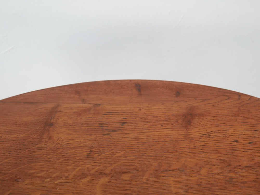 A circular oak lamp table featuring curved cross-framed legs joined by turned stretchers. View VI
