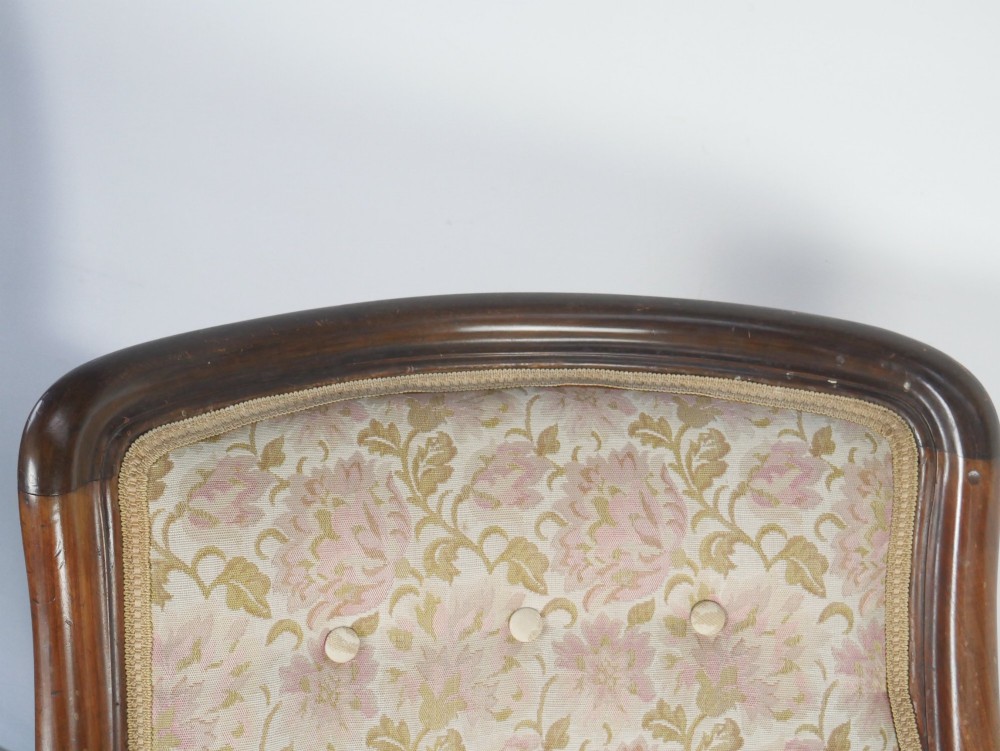 A Regency mahogany armchair with floral patterned fabric upholstery, scroll arms, reeded front legs, and brass castors. View VIII