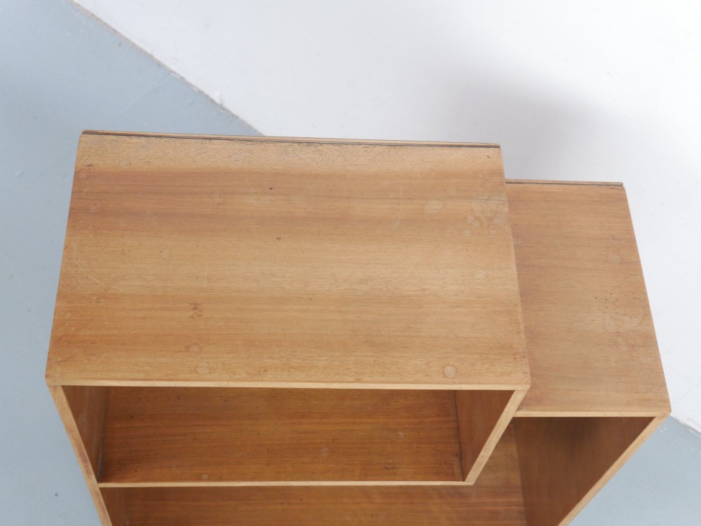 A mid-century open wooden side cabinet featuring asymmetrical shelving compartments and visible comb joints at the outer edges. View II