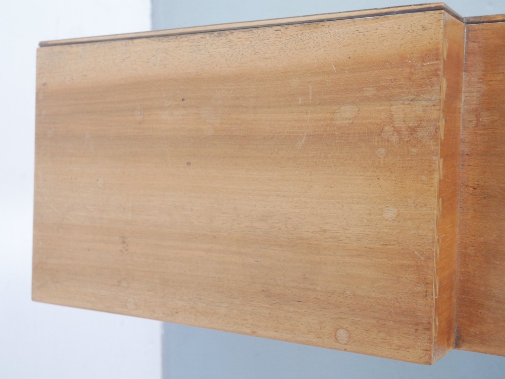 A mid-century open wooden side cabinet featuring asymmetrical shelving compartments and visible comb joints at the outer edges. View VIII